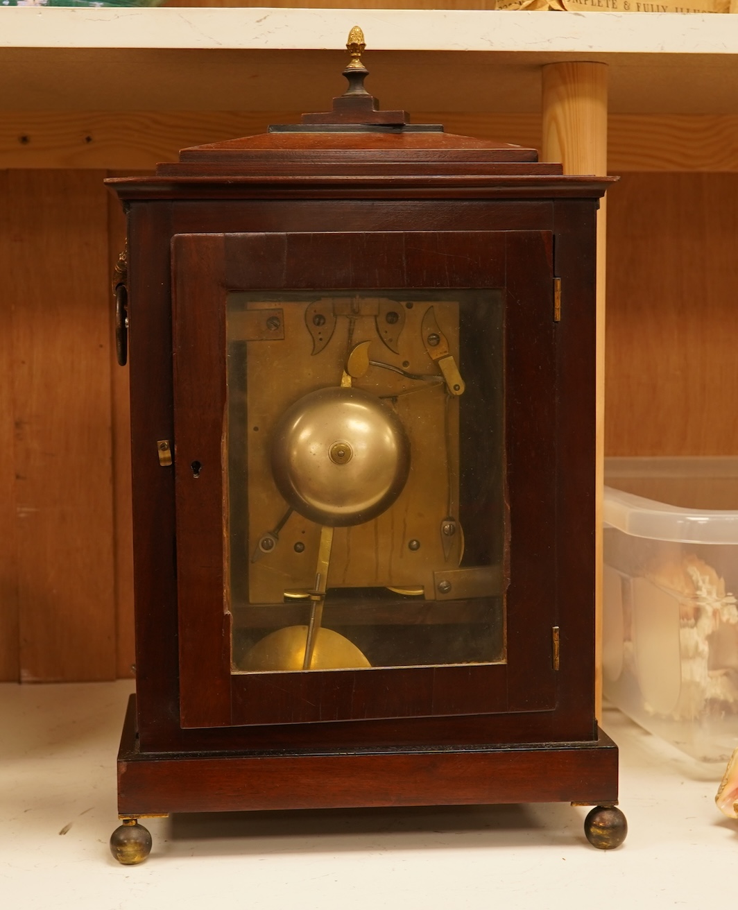 An early 19th century rosewood and brass bracket clock, striking on a bell, with pendulum and key, 47cm high